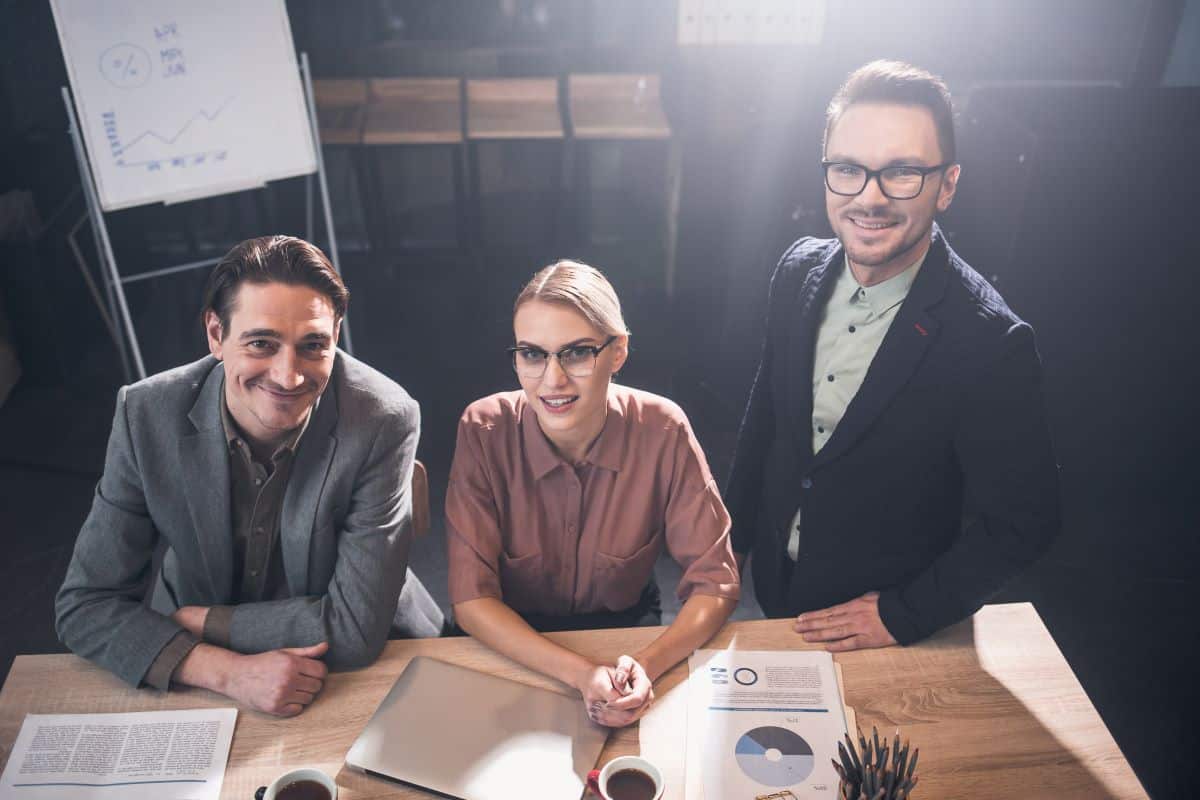 Team of three professionals around a table