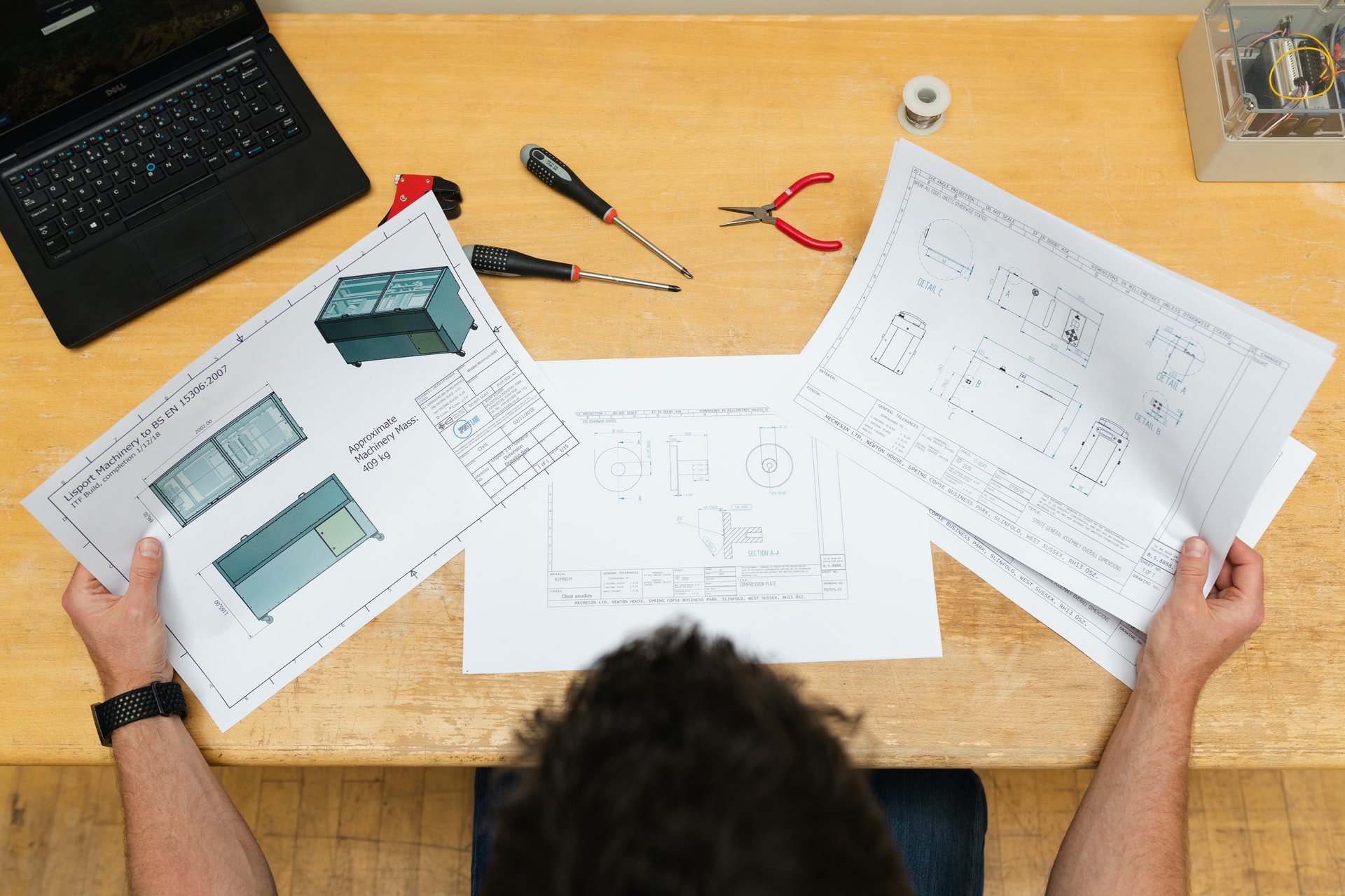 Worker at desk with various papers