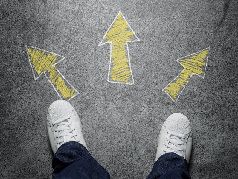 Decisions, high angle view of three arrows pointed in different directions drawn on the street