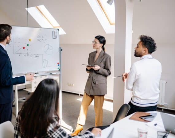 business meeting data team for article making the leap from AI investments to business results