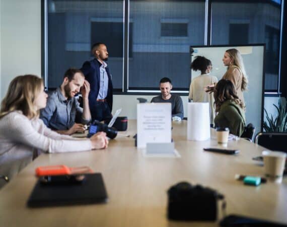 People sitting at table during strategy session or business meeting