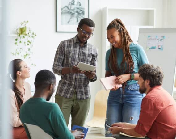 group of people sitting in circle while discussing design project in office