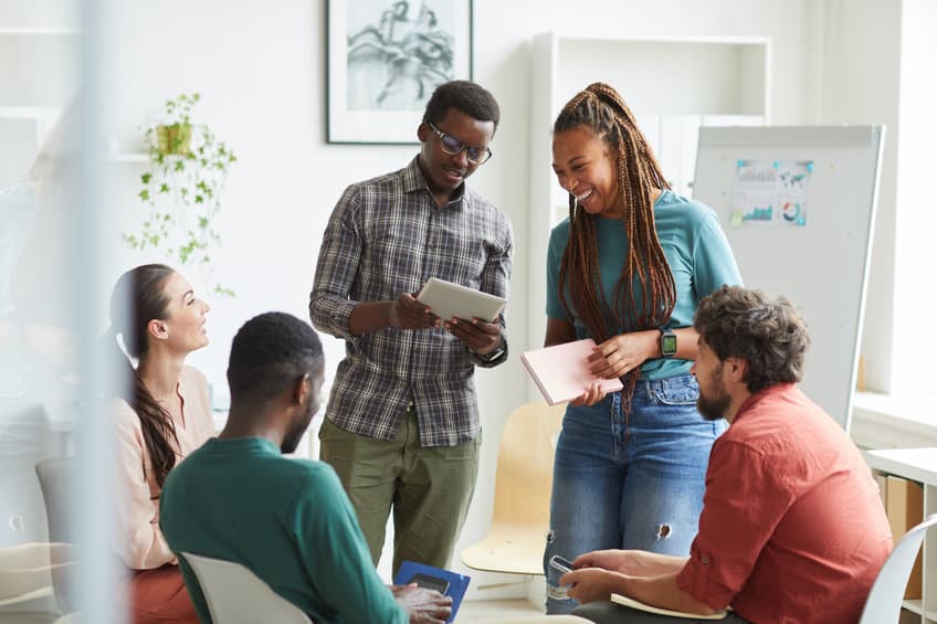 group of people sitting in circle while discussing design project in office