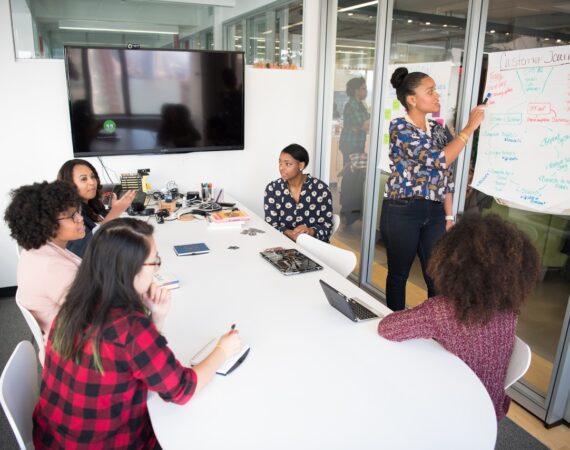 A group of professionals in a conference room, collaborating on a data analytics project.