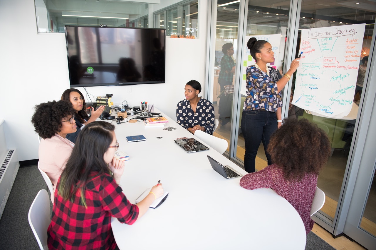 A group of professionals in a conference room, collaborating on a data analytics project.