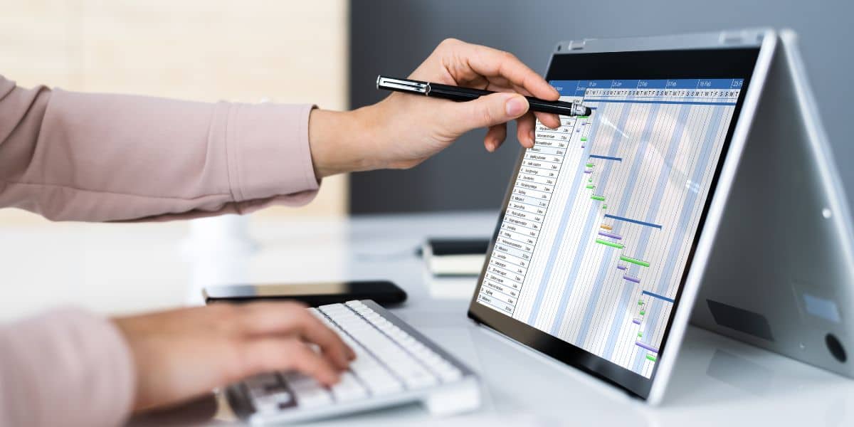 Person working on project management software on a tablet