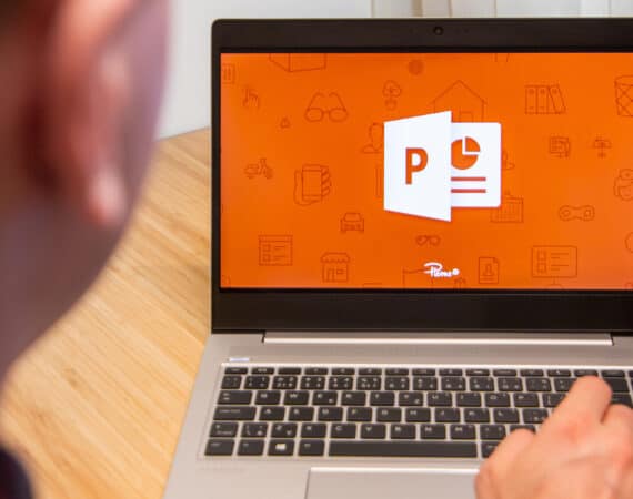 PowerPoint is used by a man on a laptop