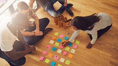 High angle view of workers sitting on floor